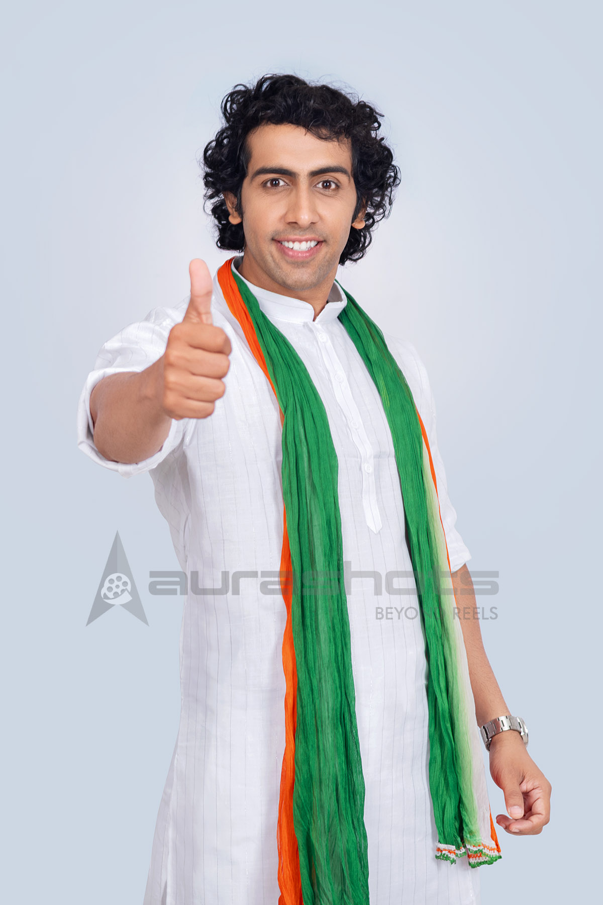 Indian man showing thumbs up wearing tricolor scarf