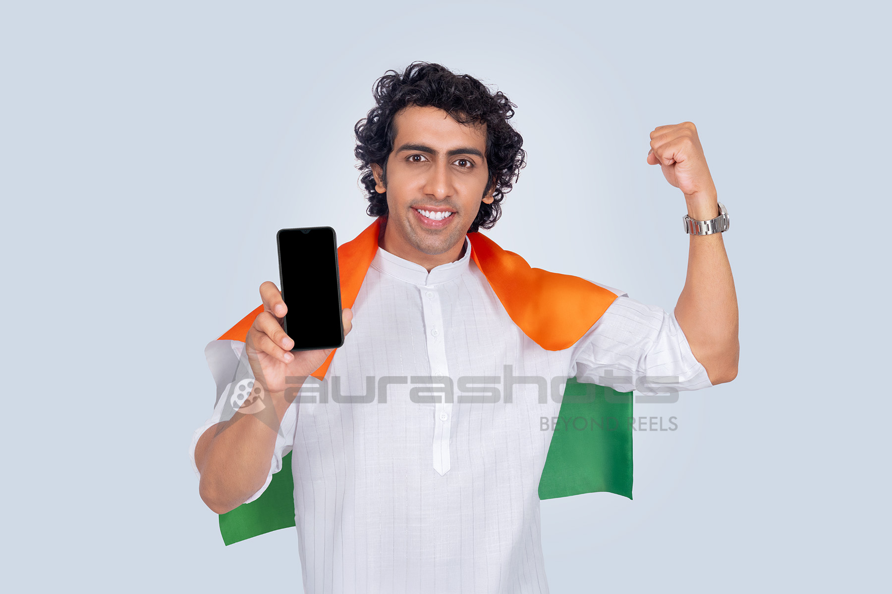 Indian man wrapped in tricolor scarf showing smartphone