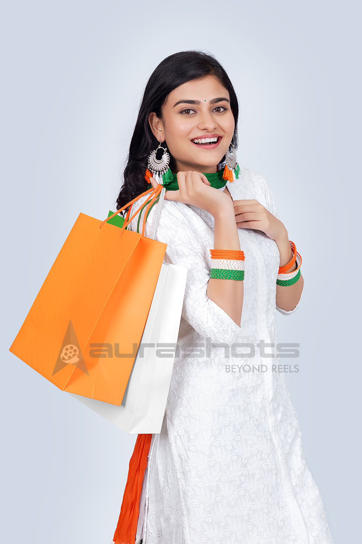 Smiling Indian woman posing with shopping bags
