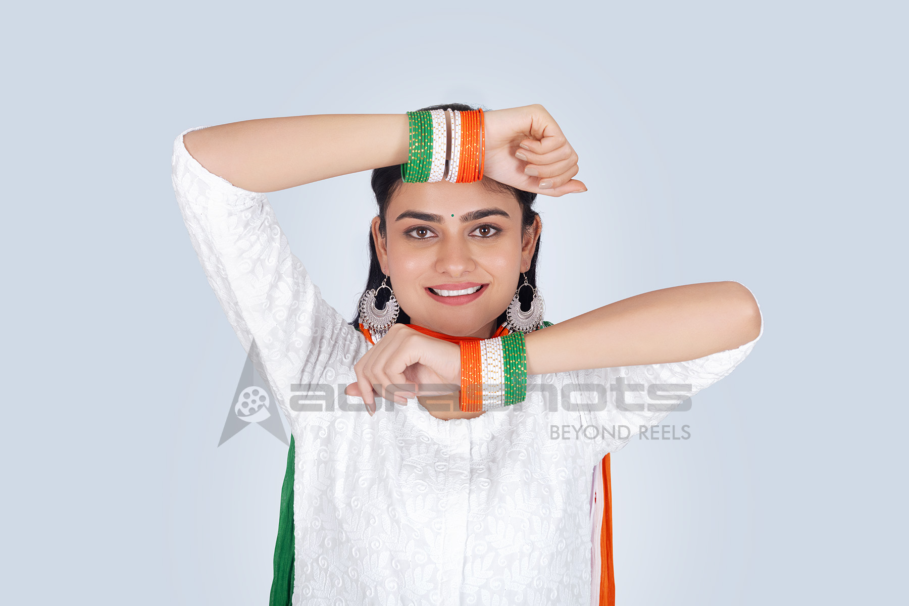 Smiling Indian woman showing tricolor bangles