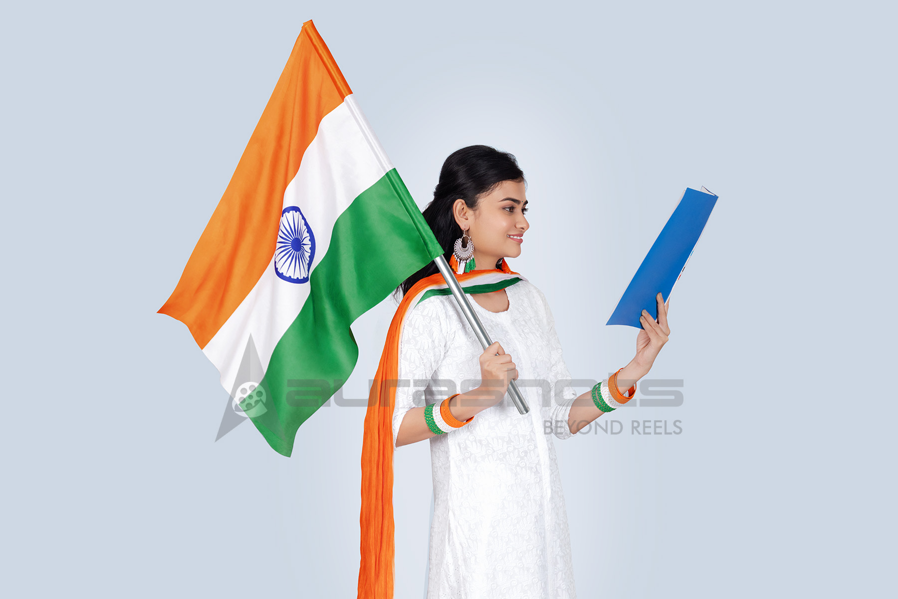 Indian woman celebrating with a flag and a blue folder