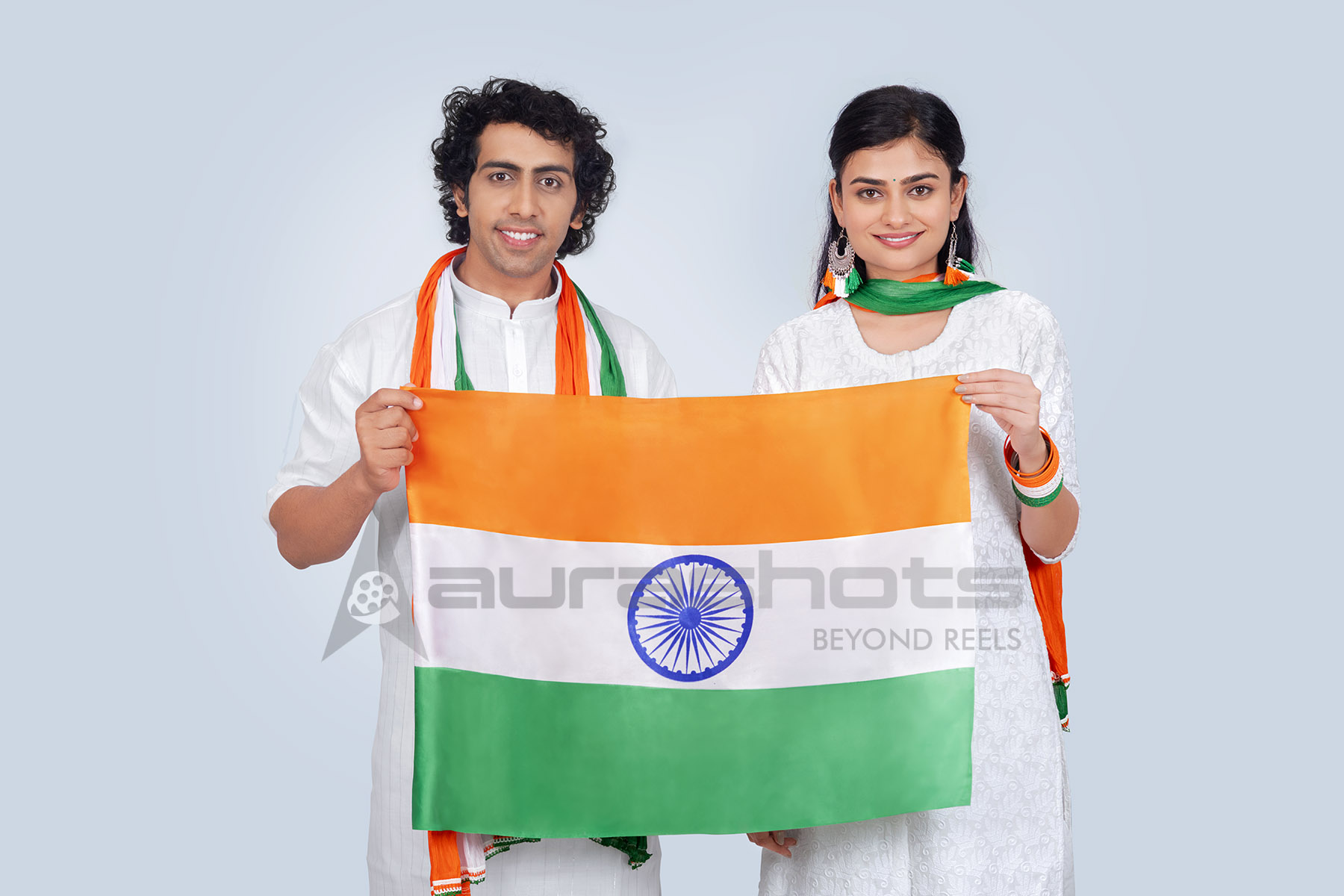 Indian couple holding national flag with smiles