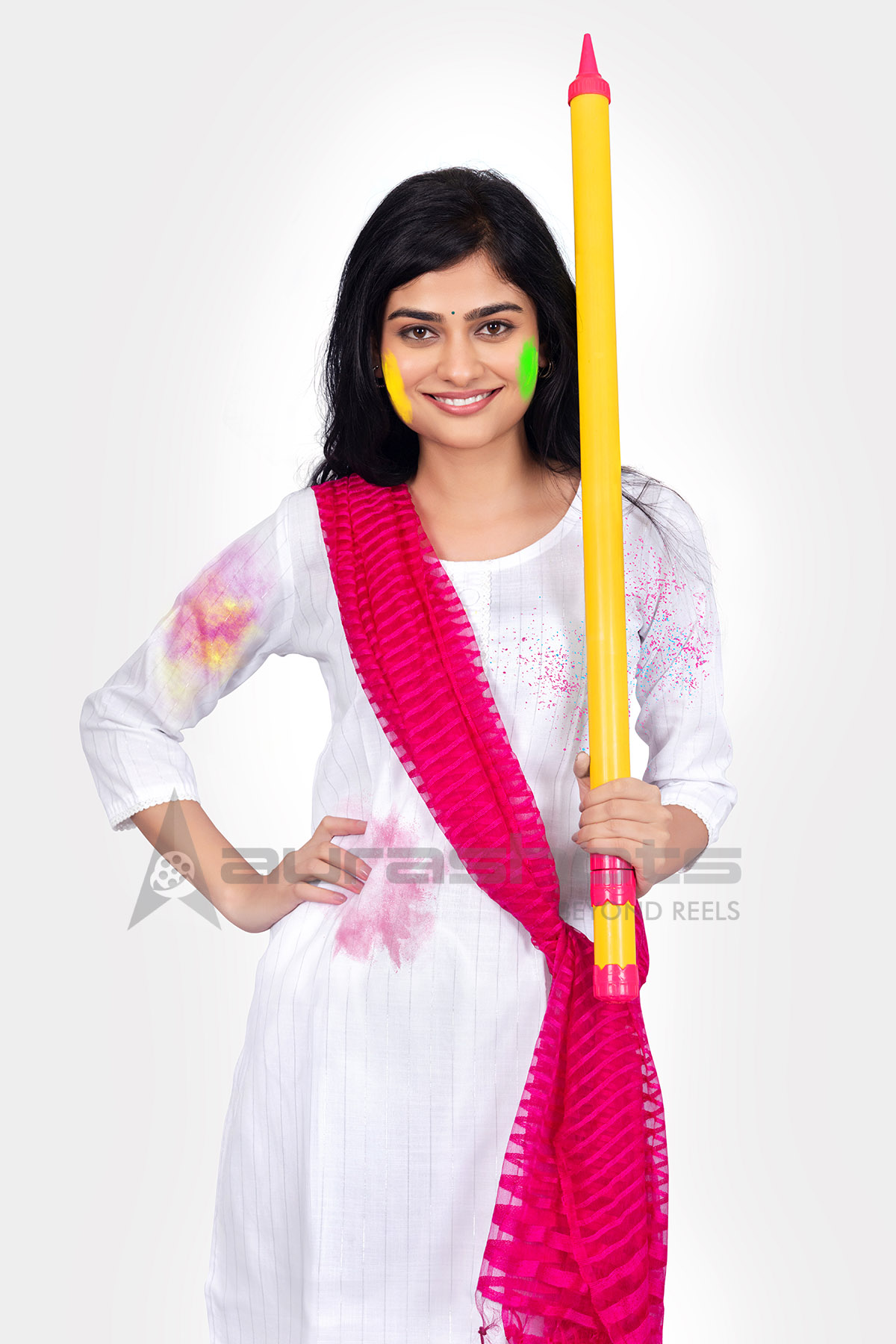 Indian woman holding a pichkari for the Holi celebration