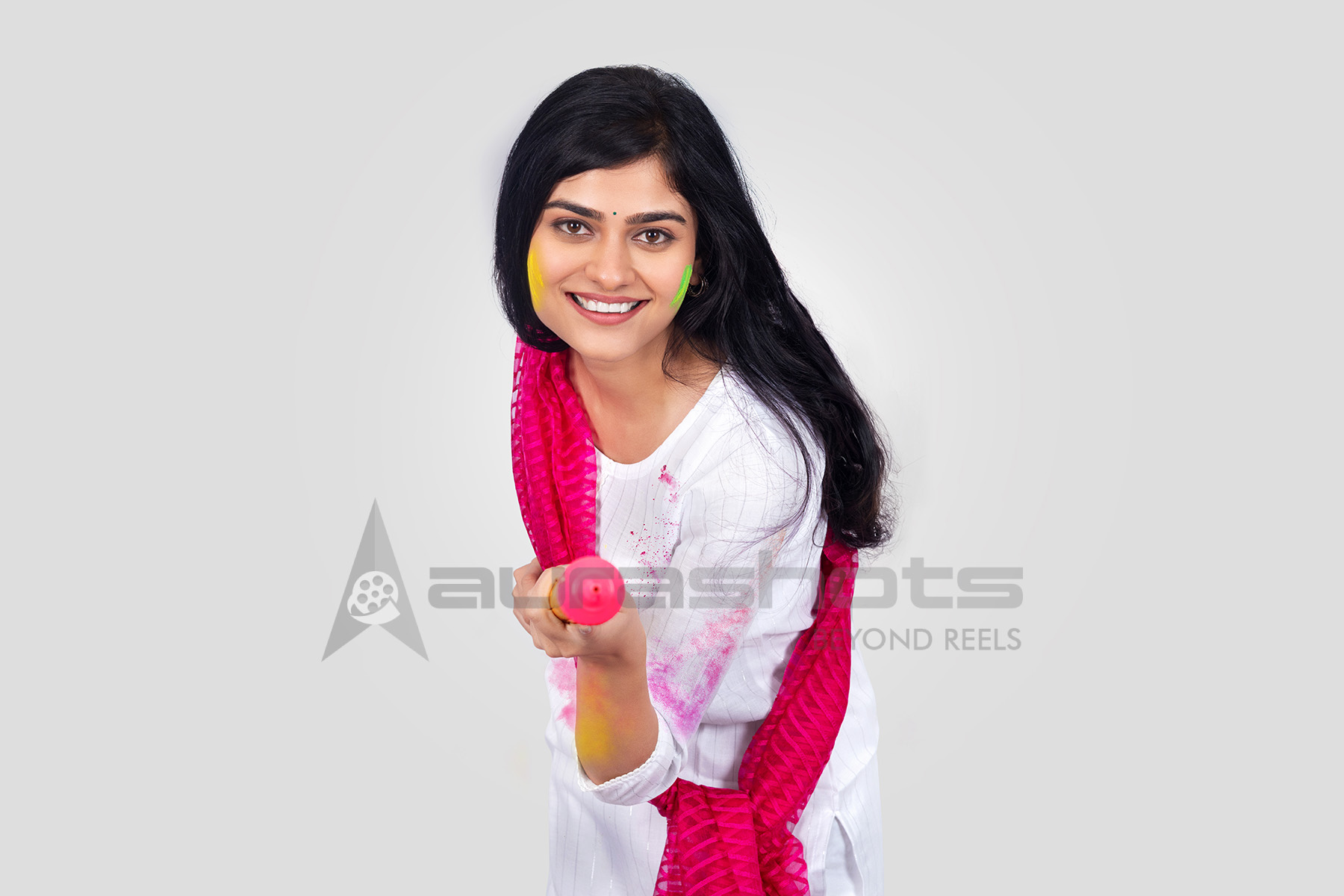 Smiling Indian woman showing playful gesture during Holi