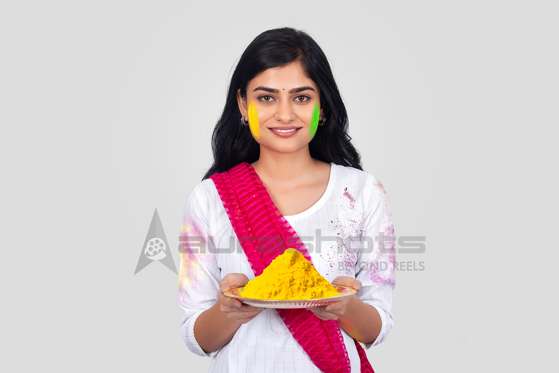Indian woman holding gulal during Holi