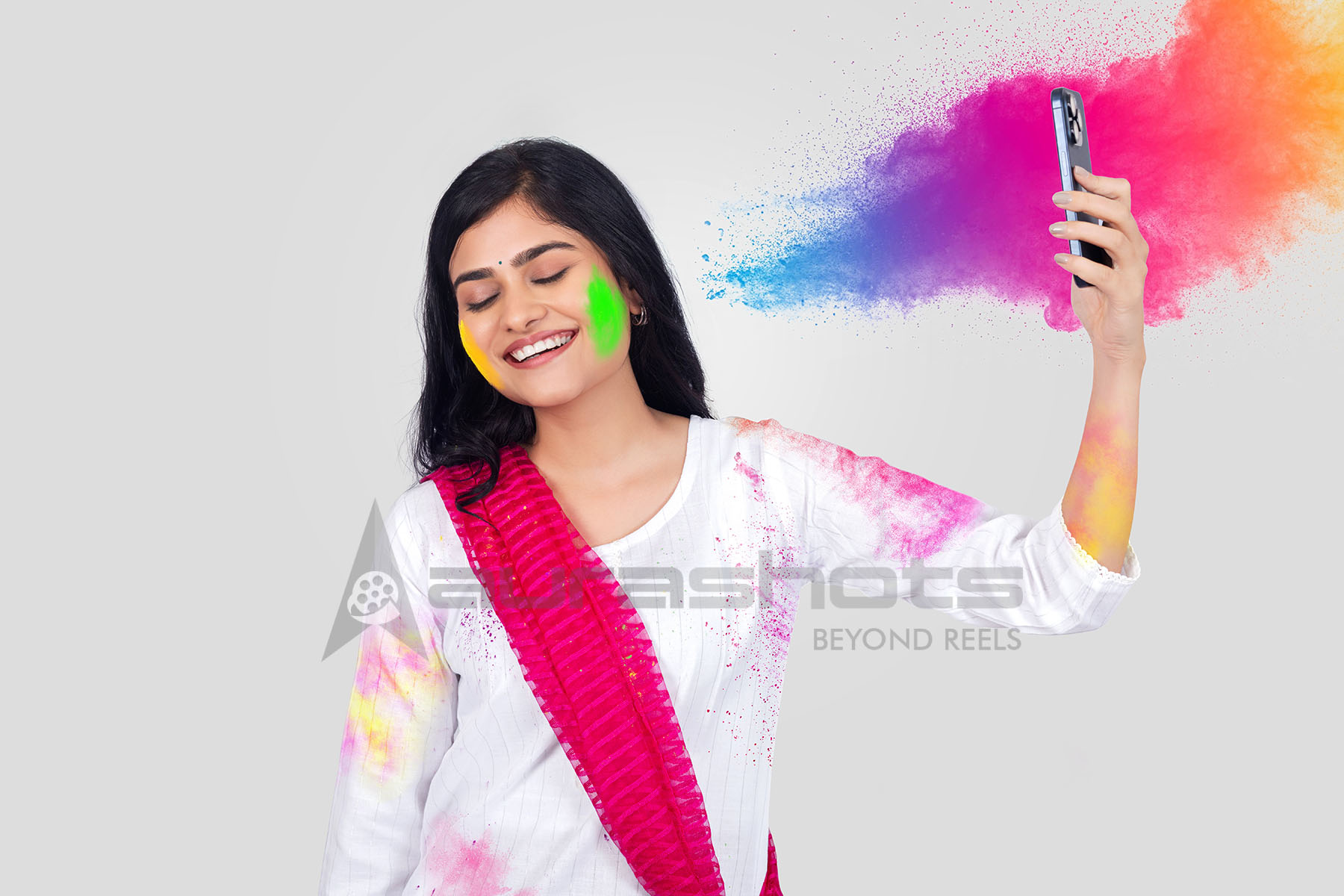 Indian woman taking selfie during Holi festival