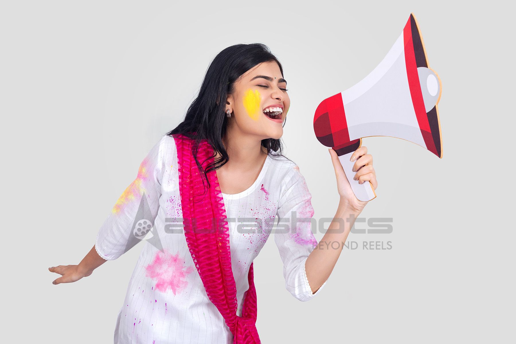 Indian woman shouting through megaphone with excitement