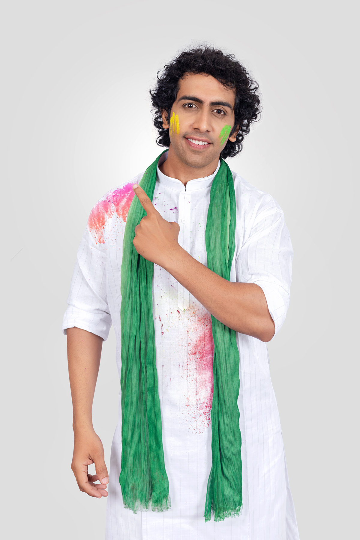 Indian man wearing a green scarf in traditional Pose