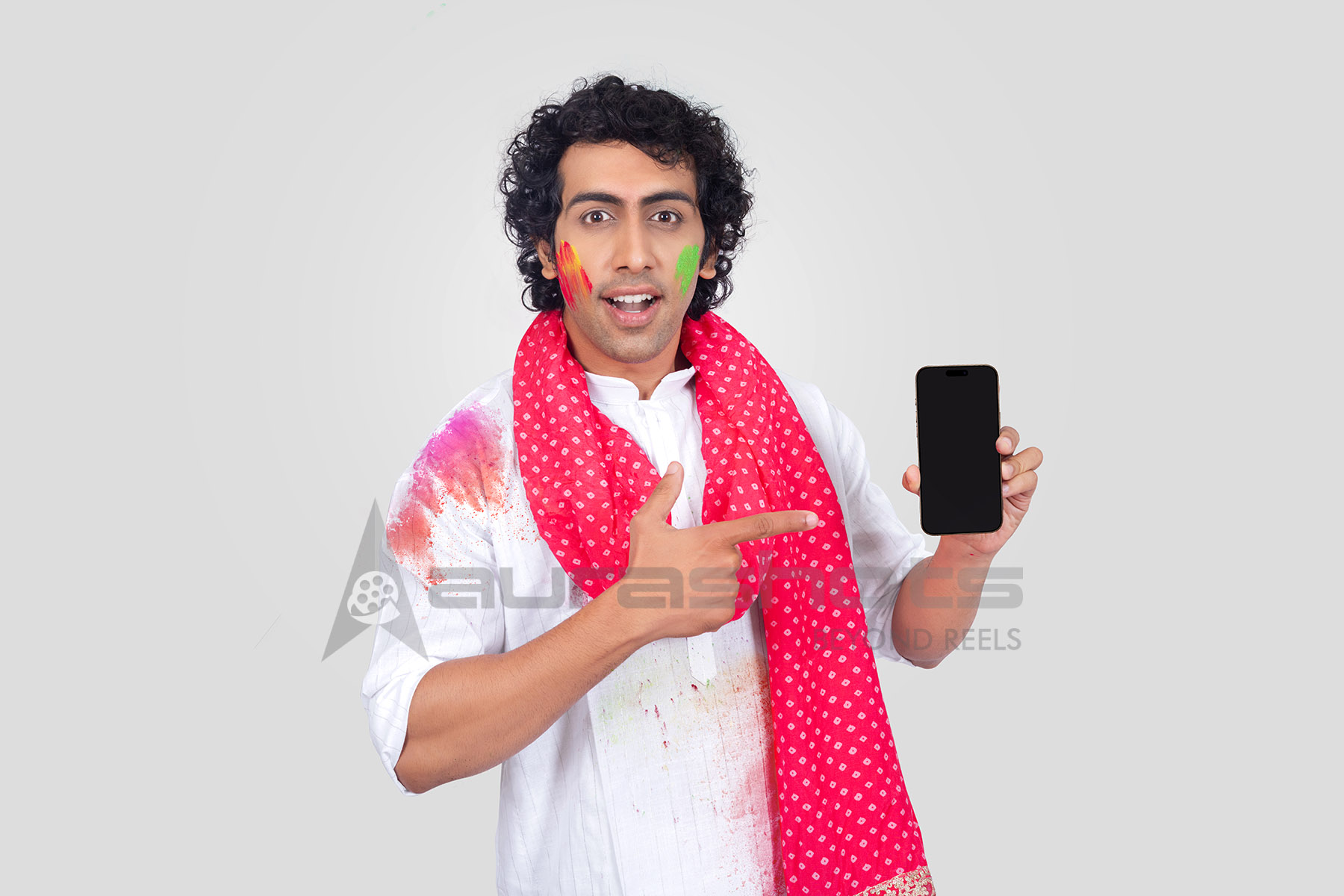 Festive Indian man pointing at smartphone