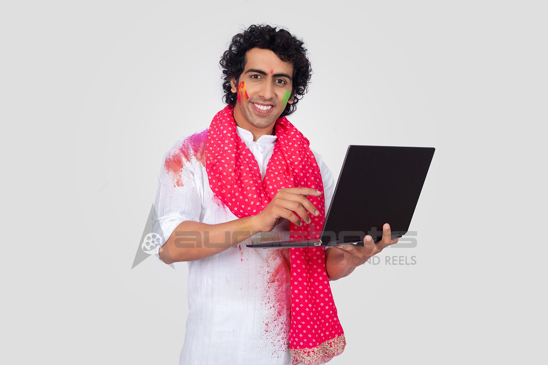 Indian man working on a laptop during the festive season