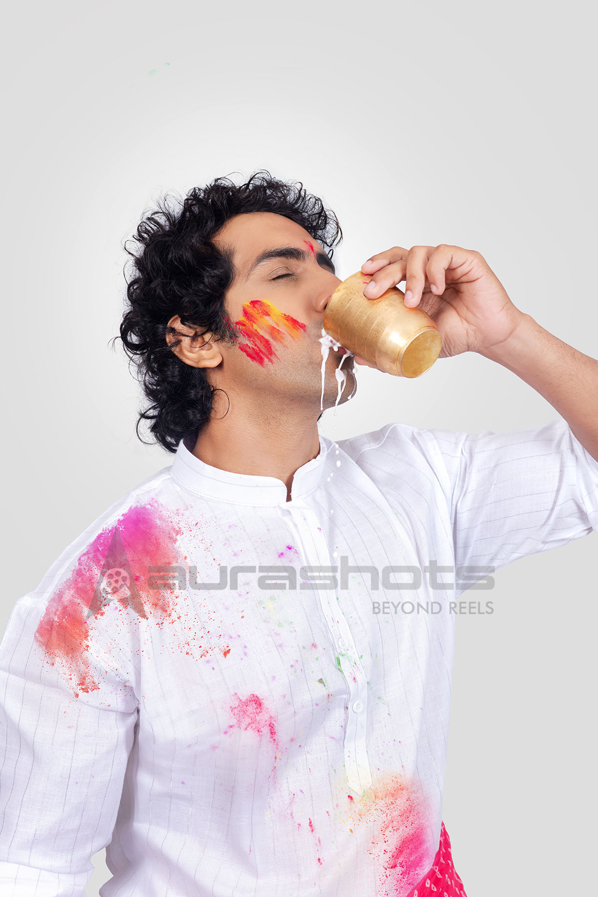 A man drinking thandai during Holi celebration