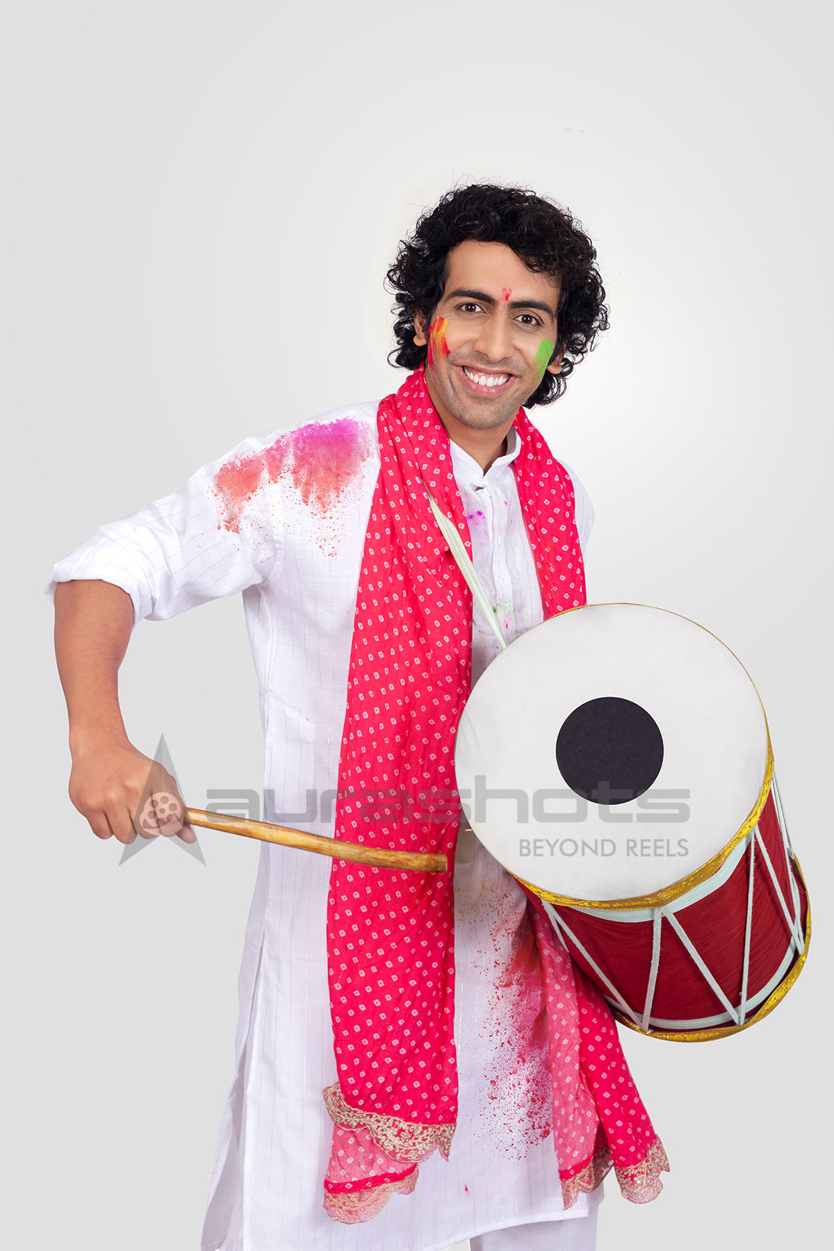 Man playing the dhol during the Holi celebration