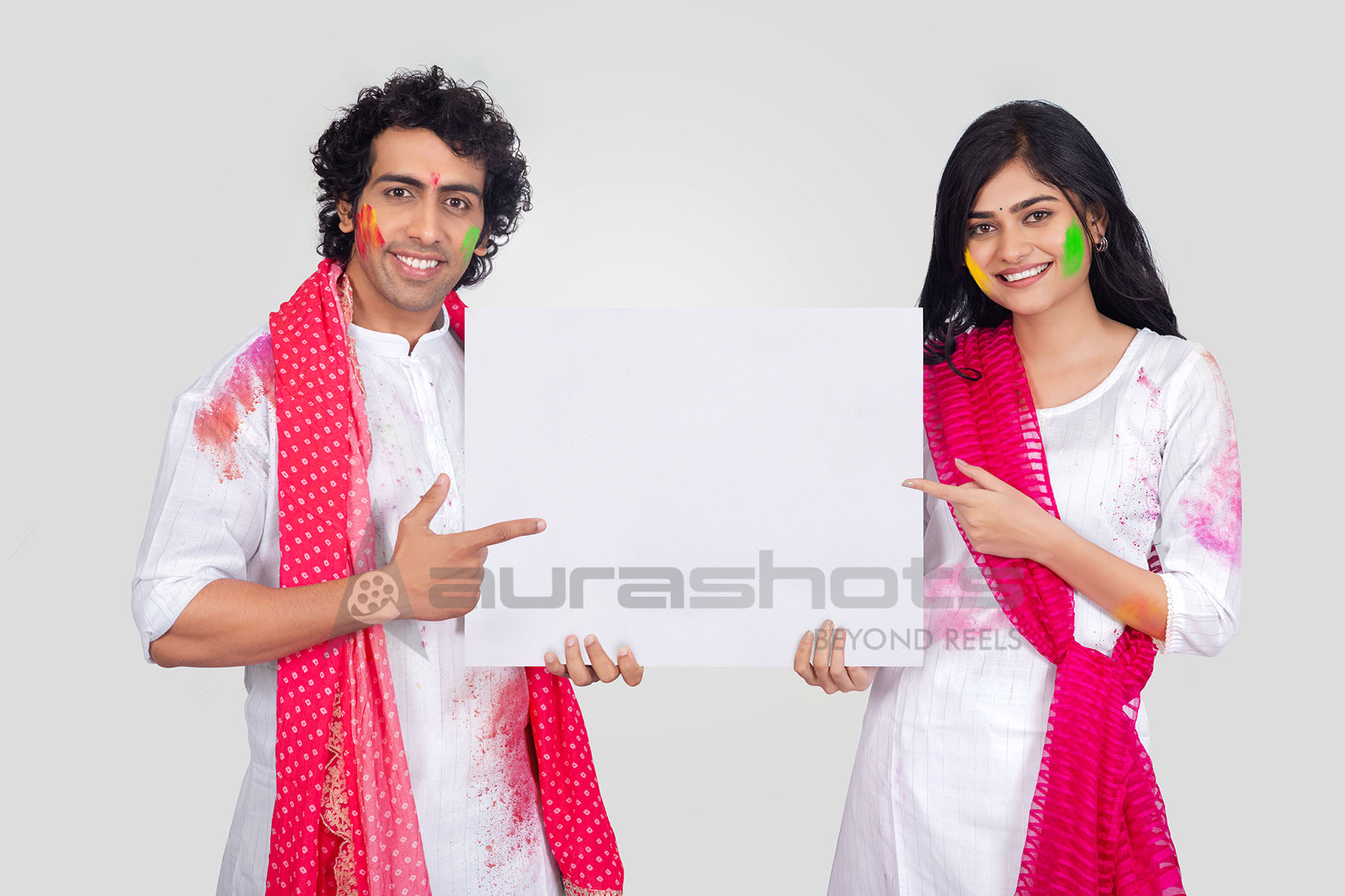 Couple holding ofer board for holi wishes
