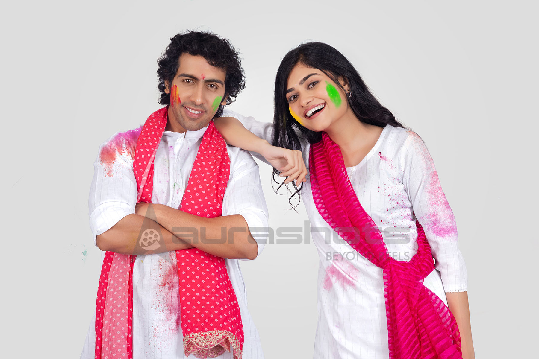 Couple posing together in traditional Holi attire