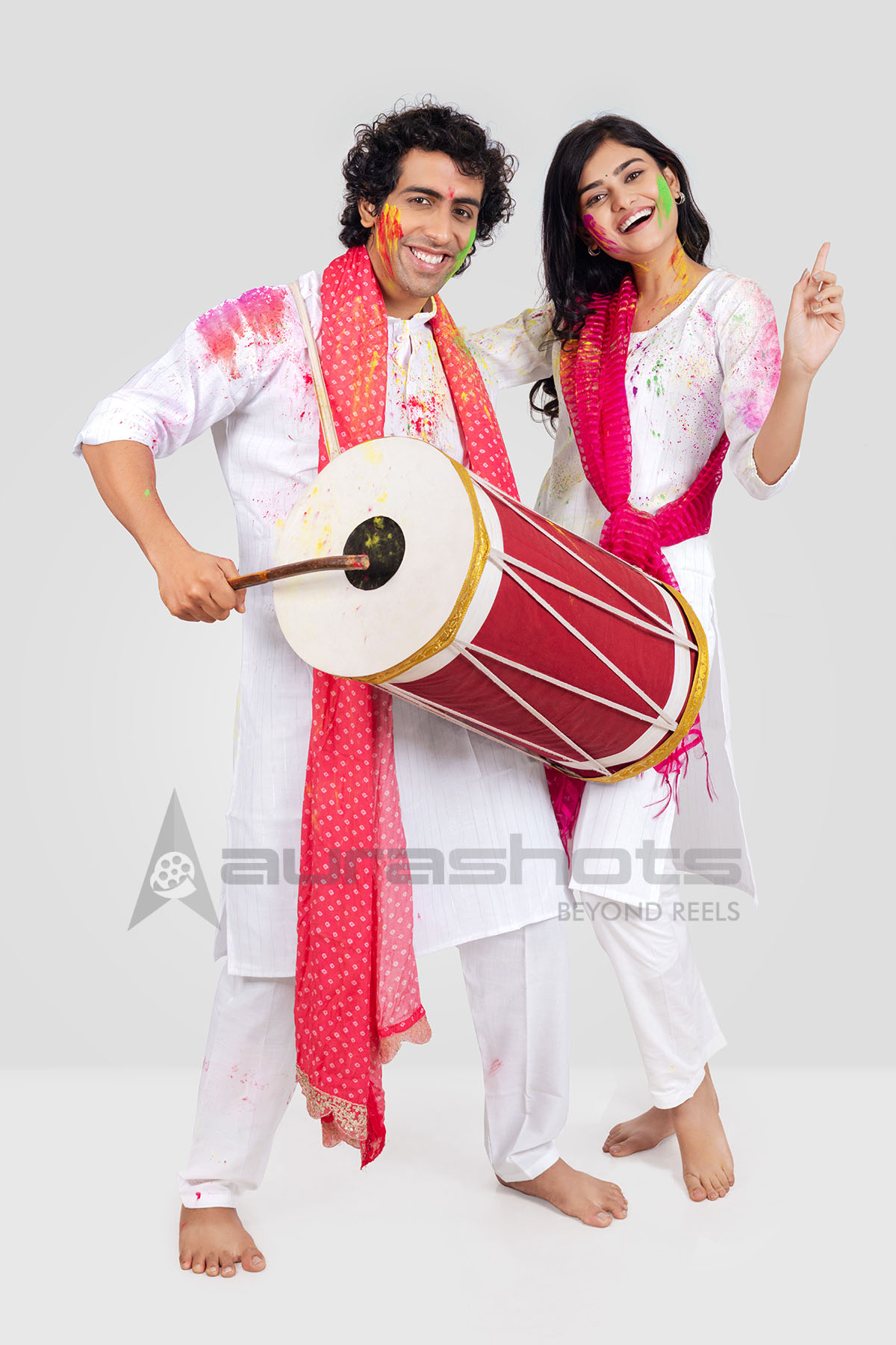 Couple celebrating Holi with dhol and dance