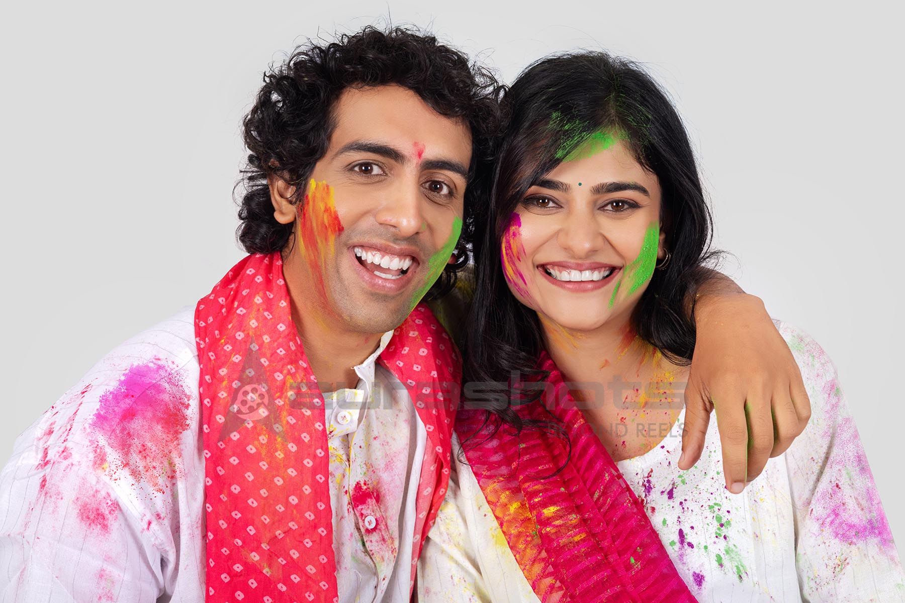 Couple celebrating Holi with colorful gulal and festive joy