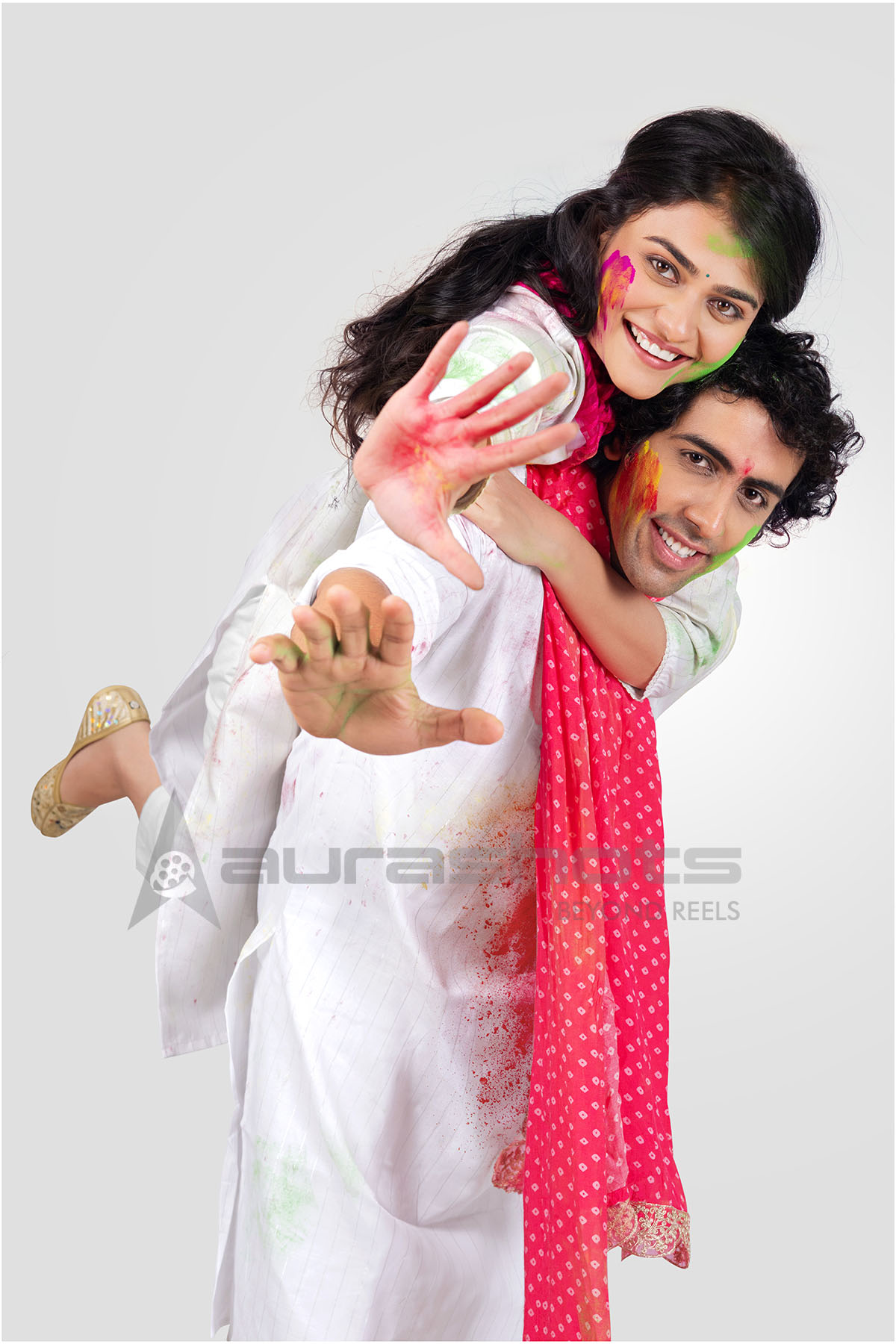 Couple celebrating Holi with bright colors and laughter