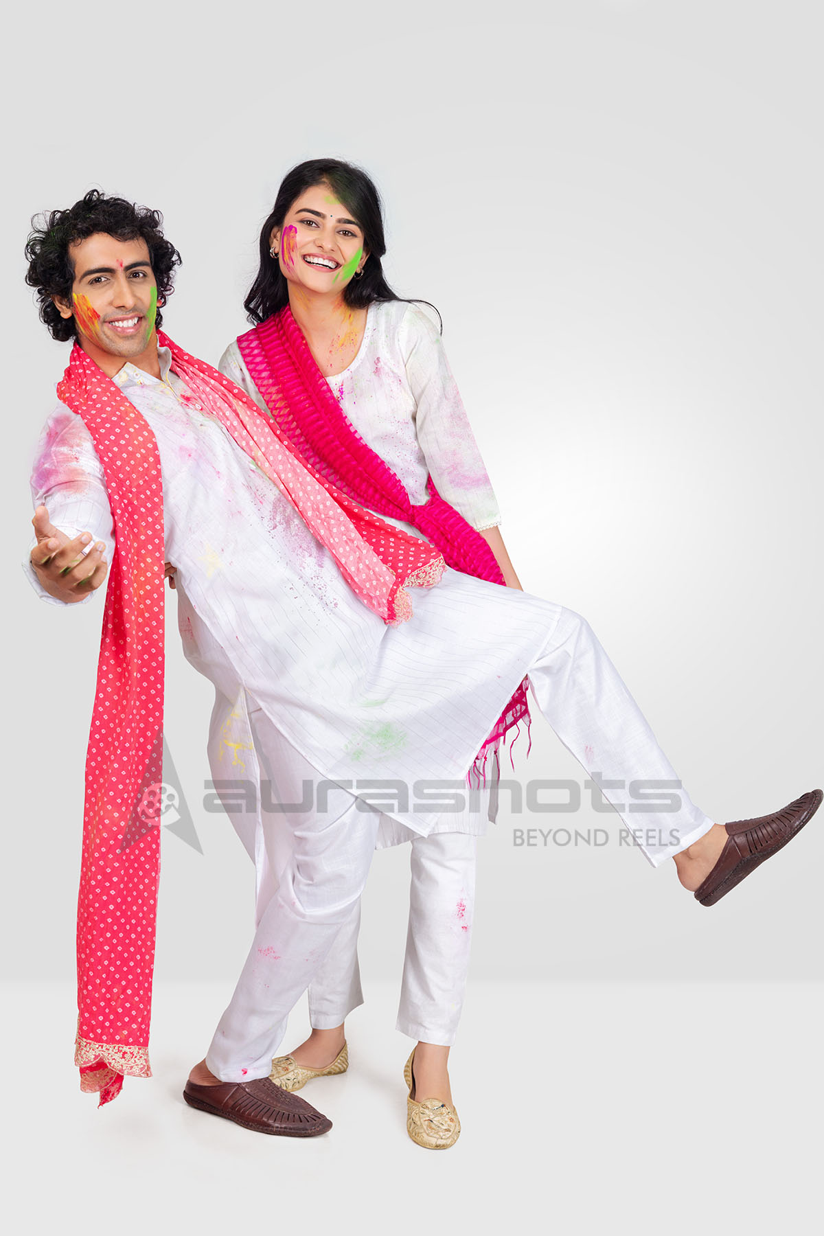 Couple celebrating Holi together in traditional attire