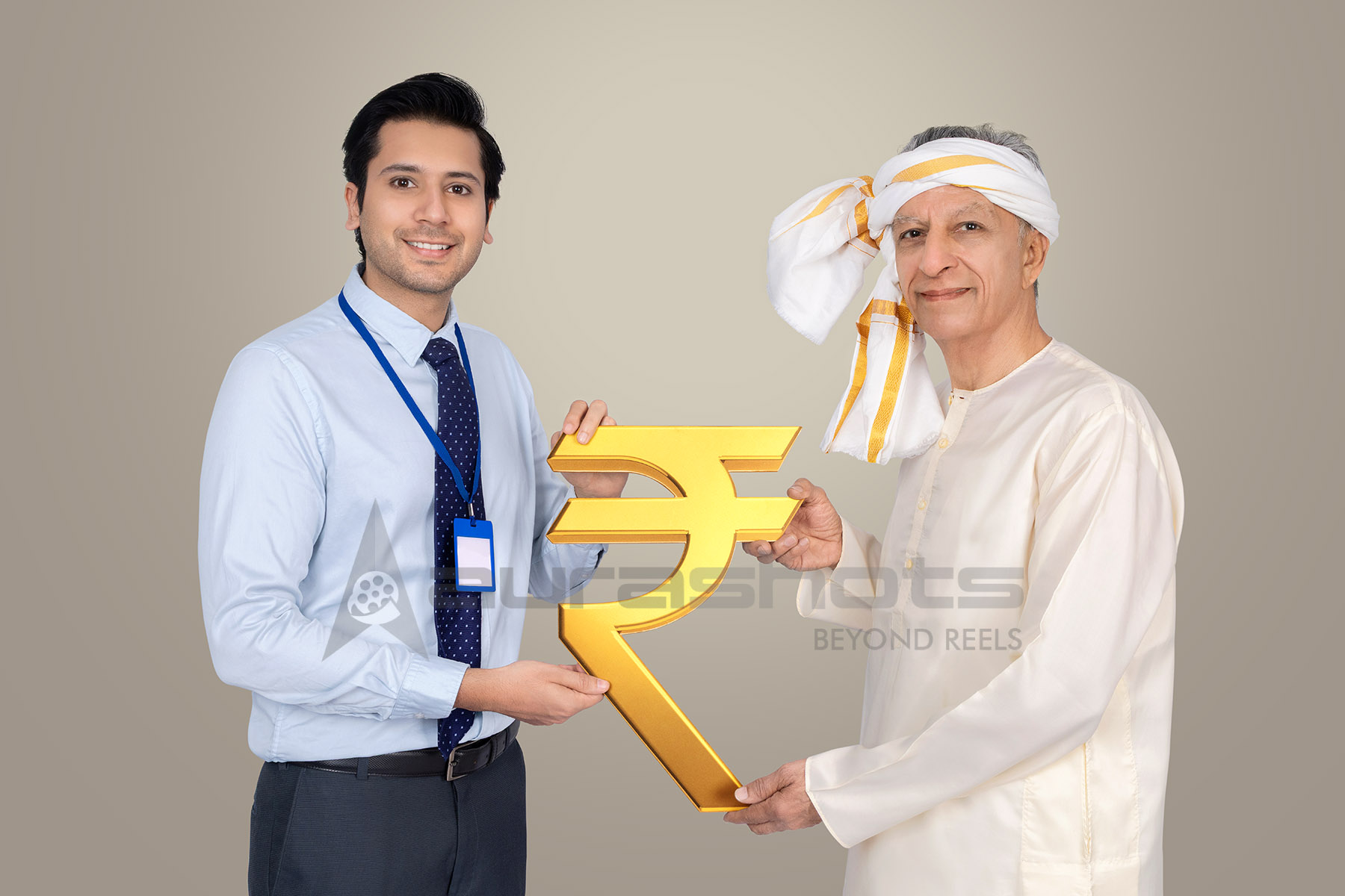 Rural Indian senior and banker holding rupee symbol