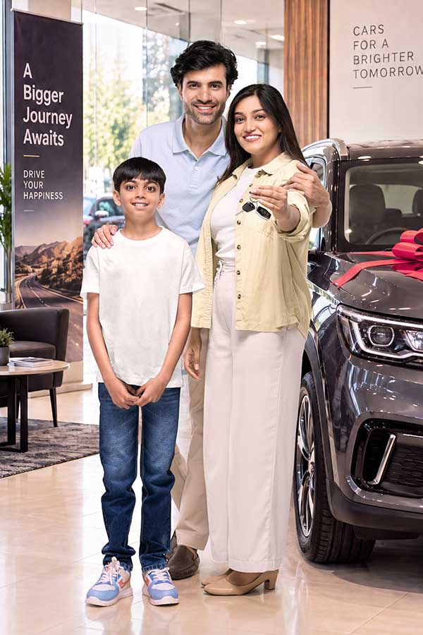 Indian family celebrating new car purchase at automobile dealership