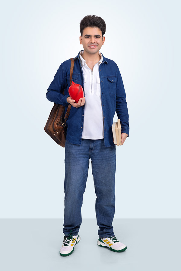 Indian student holding Gullak and notebook in studio portrait