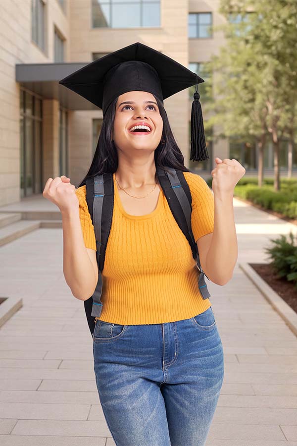Happy Indian graduate student celebrating academic achievement outdoors