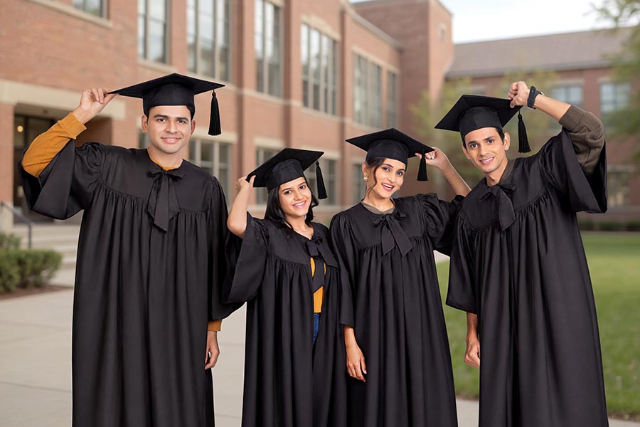 Young Indian graduates posing together outdoors after convocation