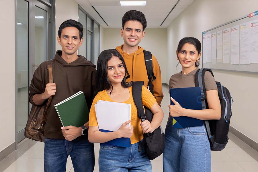 Group of Indian college students standing together in campus corridor
