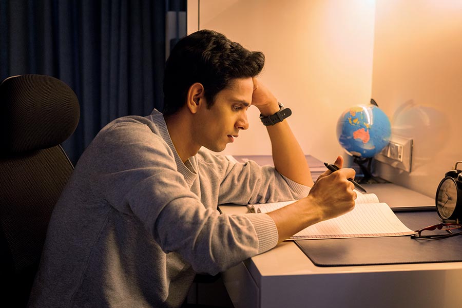 Indian student studying late night at home desk