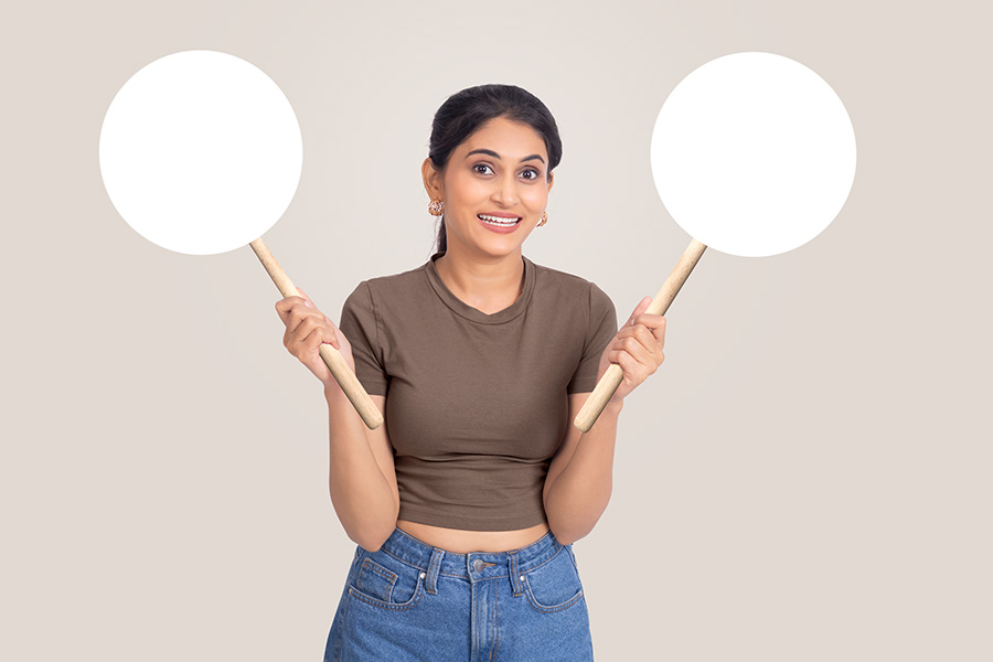 Young Indian woman holding blank circular signboards for promotion