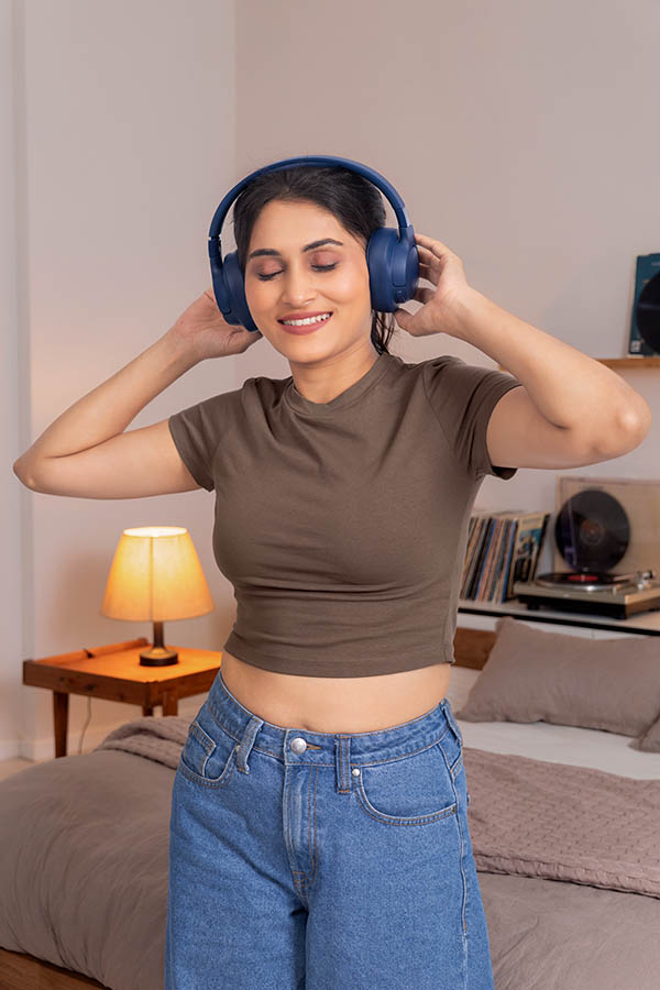 Indian woman relaxing with headphones and enjoying audio experience