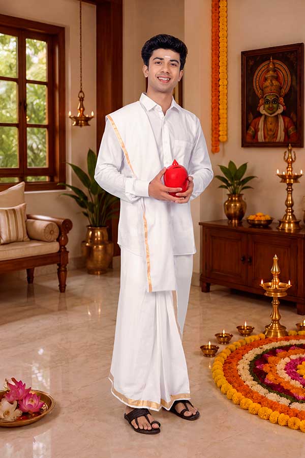 Young Indian man holding traditional red gullak during Onam celebration