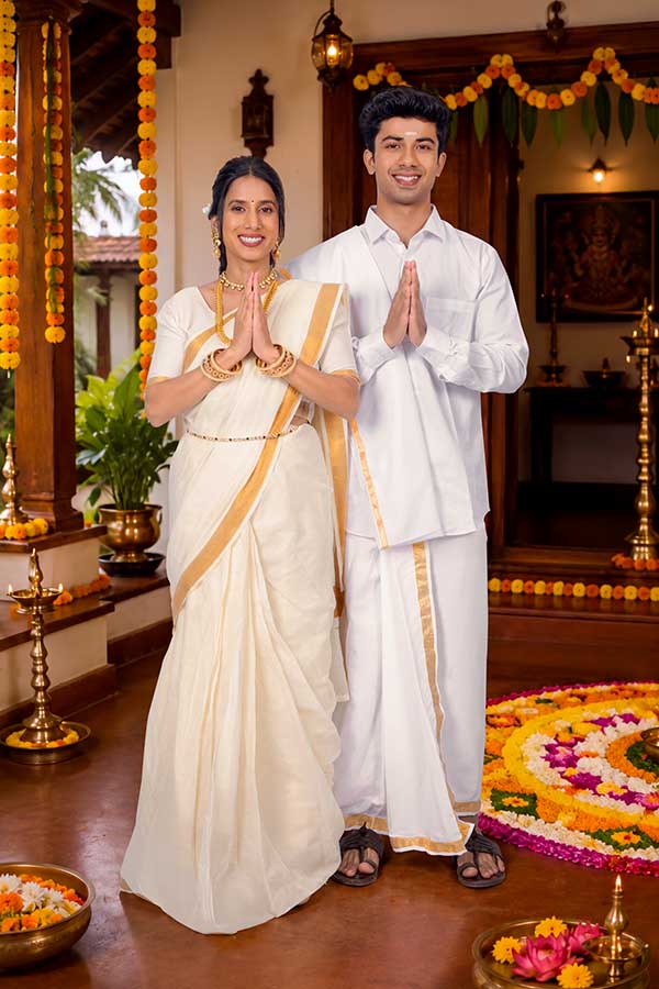 Indian couple greeting with namaste during Onam festival celebration