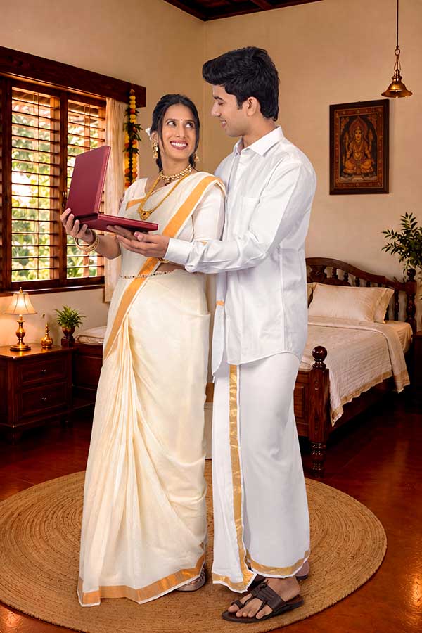 Kerala couple opening festive jewellery gift box during Onam