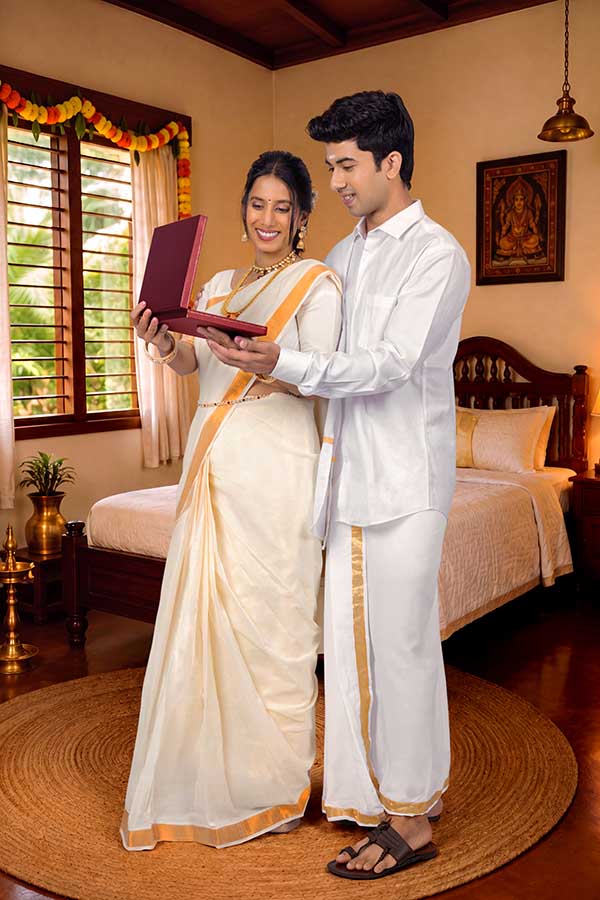 Kerala couple admiring traditional jewellery during Onam celebration