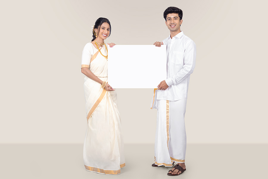 Indian couple holding blank white signboard for Onam promotion