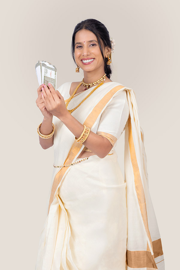 Indian woman holding Indian currency notes during Onam festival