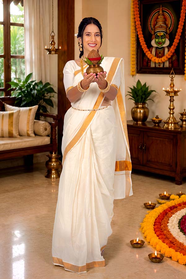 Kerala woman holding traditional kalash during Onam festivities
