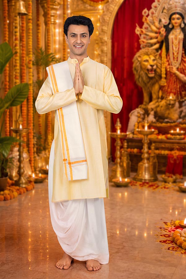 Indian man praying before Durga idol during Durga Puja
