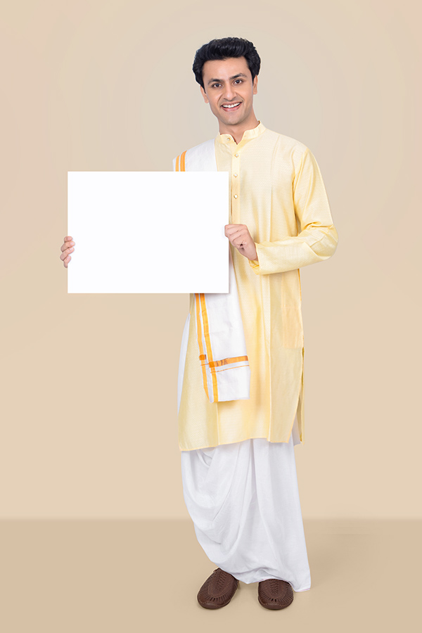 Indian man holding blank placard in traditional attire for festive advertising