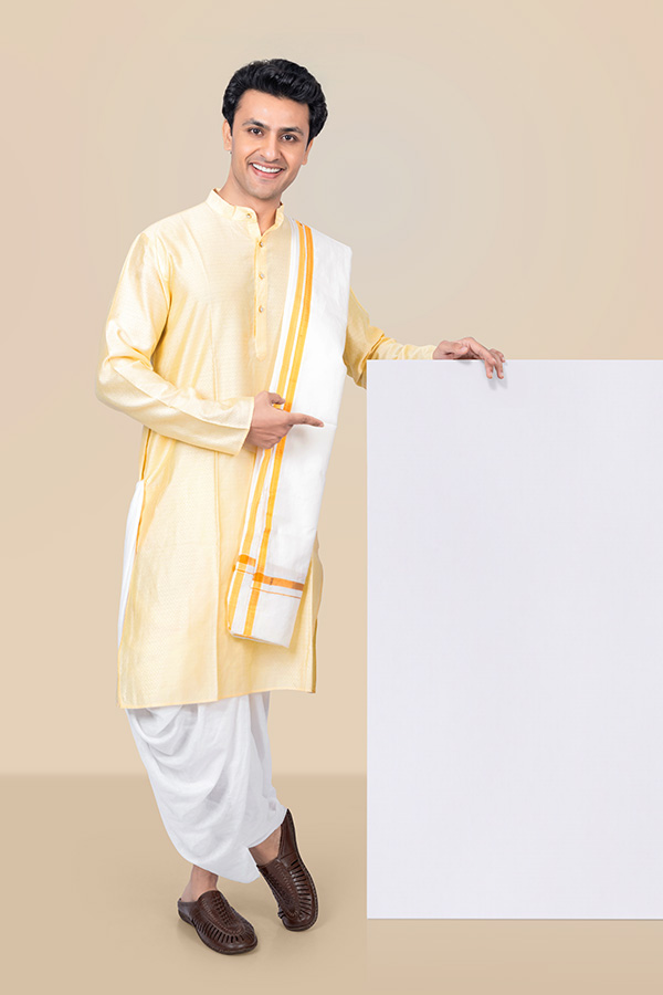 Indian man pointing at blank signboard in traditional attire for Durga Puja advertising