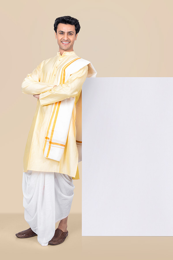 Indian man standing with crossed arms beside blank signboard for festive advertising