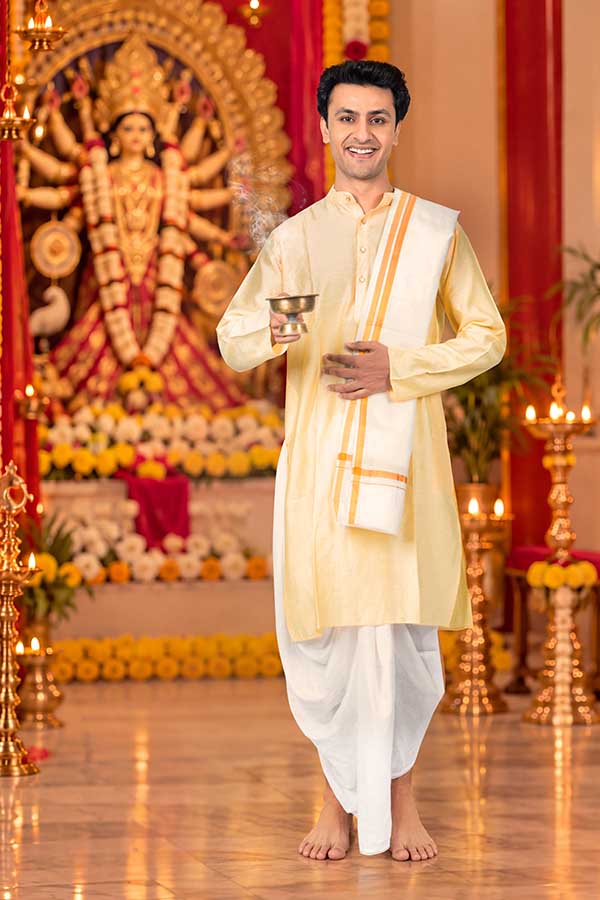 Indian man performing devotional Durga Puja worship with incense burner