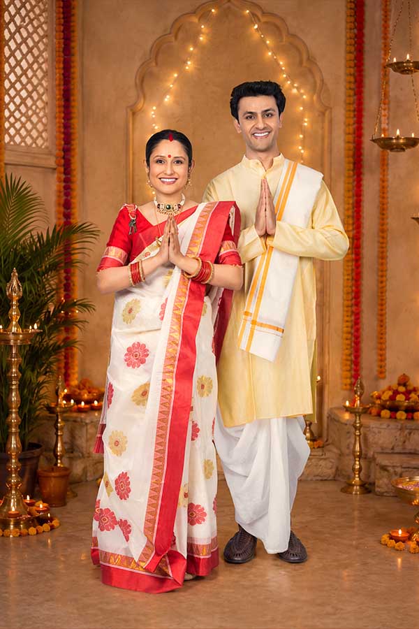 Indian couple offering prayers during traditional Durga Puja celebration