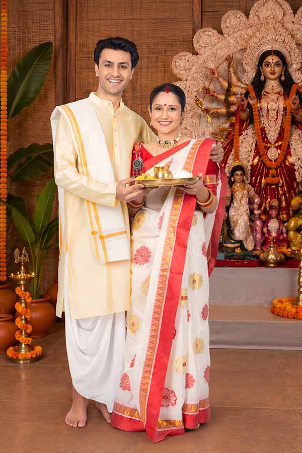 Indian couple offering puja thali during Durga Puja celebration