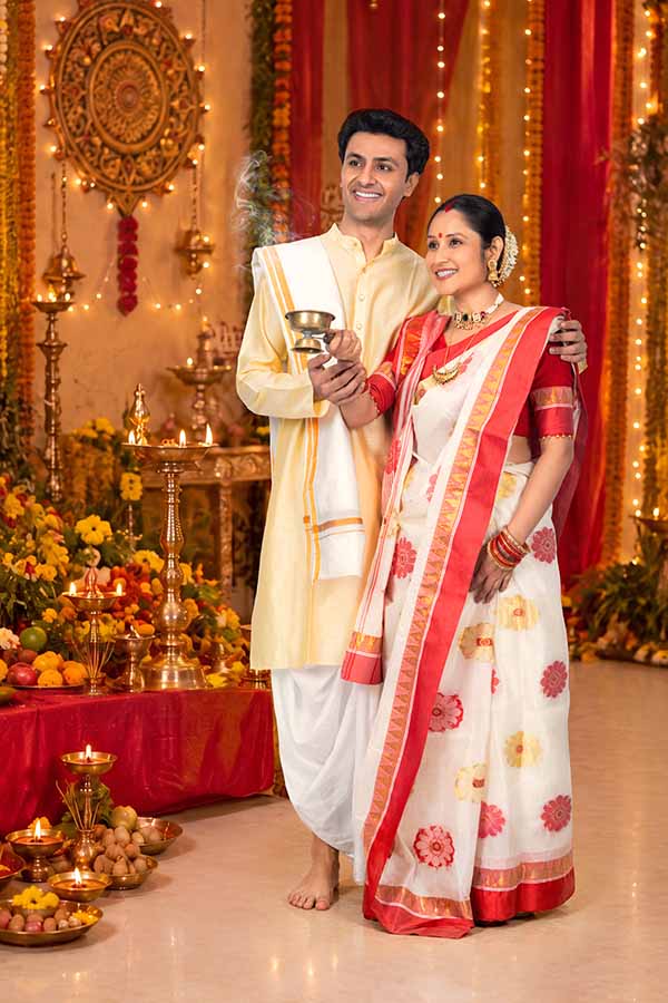 Indian couple performing incense ritual during Durga Puja celebration