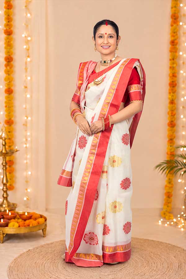 Bengali woman posing in traditional saree during festive celebration
