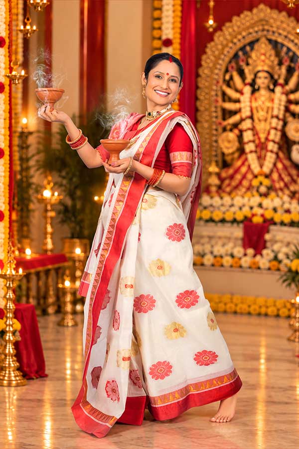 Bengali woman performing dhunuchi ritual during Durga Puja