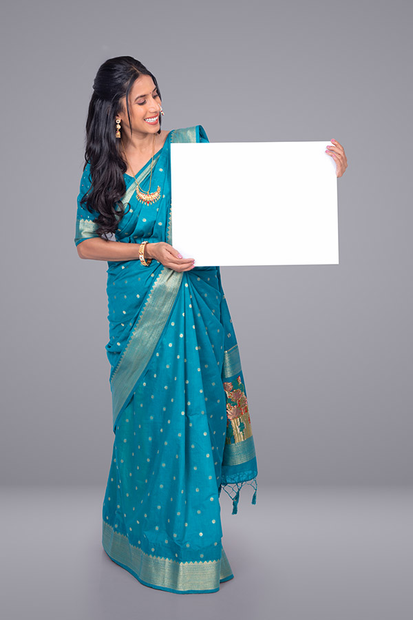 Indian woman displaying blank signboard for advertising message