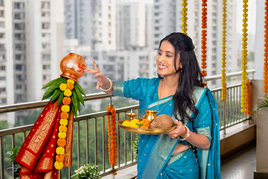 Indian woman performing Gudi Padwa ritual with festive puja thali